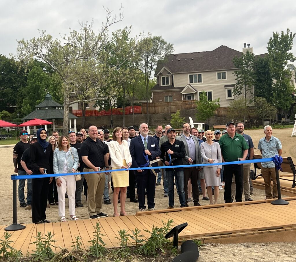 Group cutting ribbon at bangs lake.